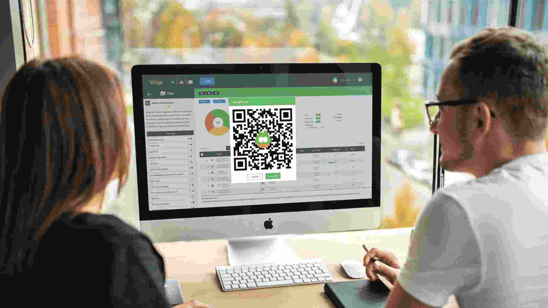 employees looking at QR code on computer