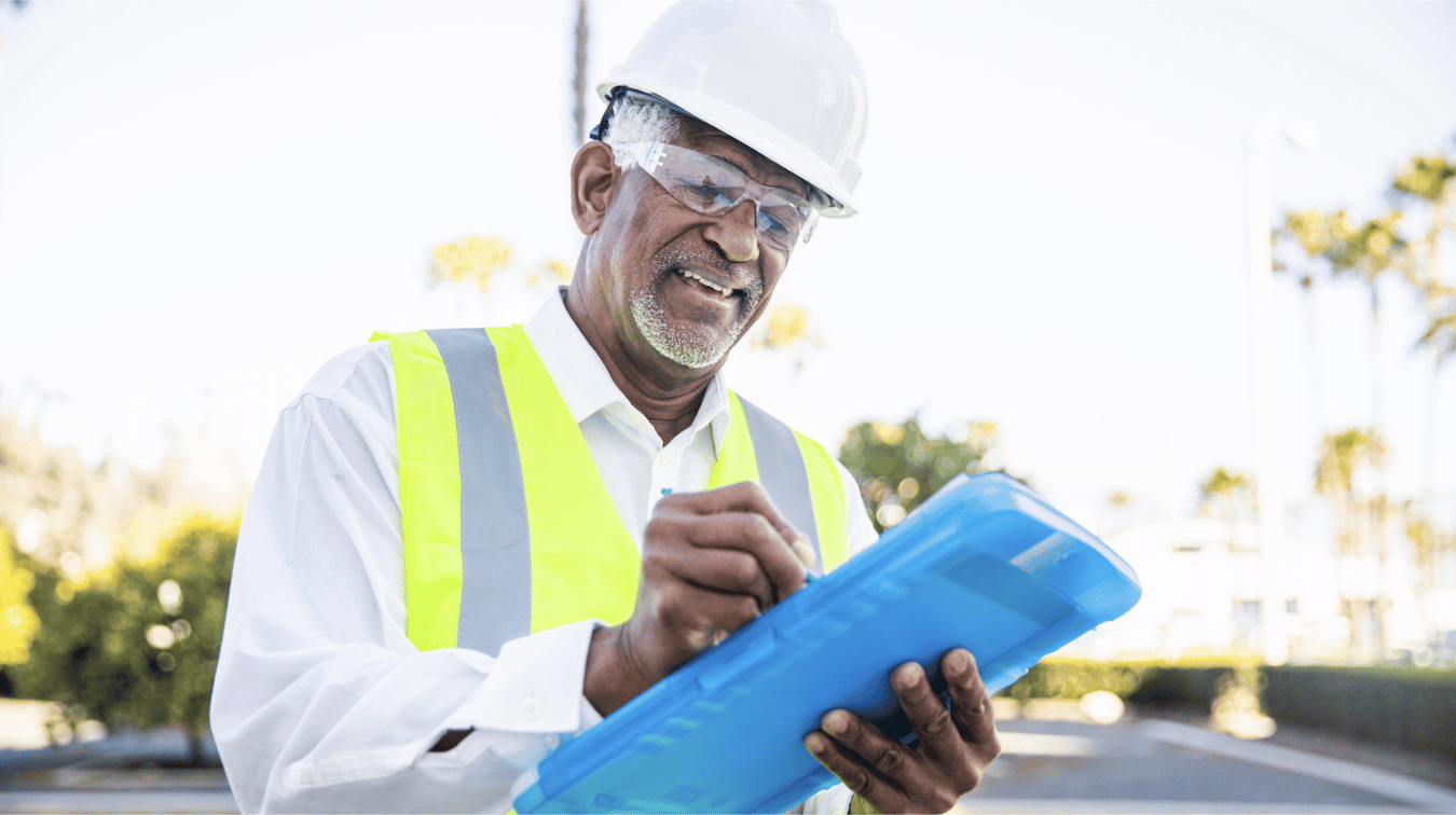man looking at clipboard