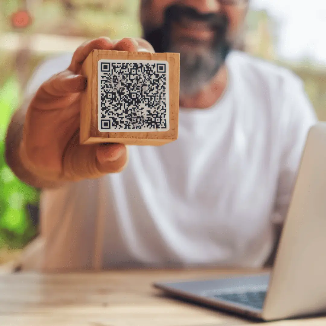 qr code on a wood block being held by worker  - 10 2023 (1)